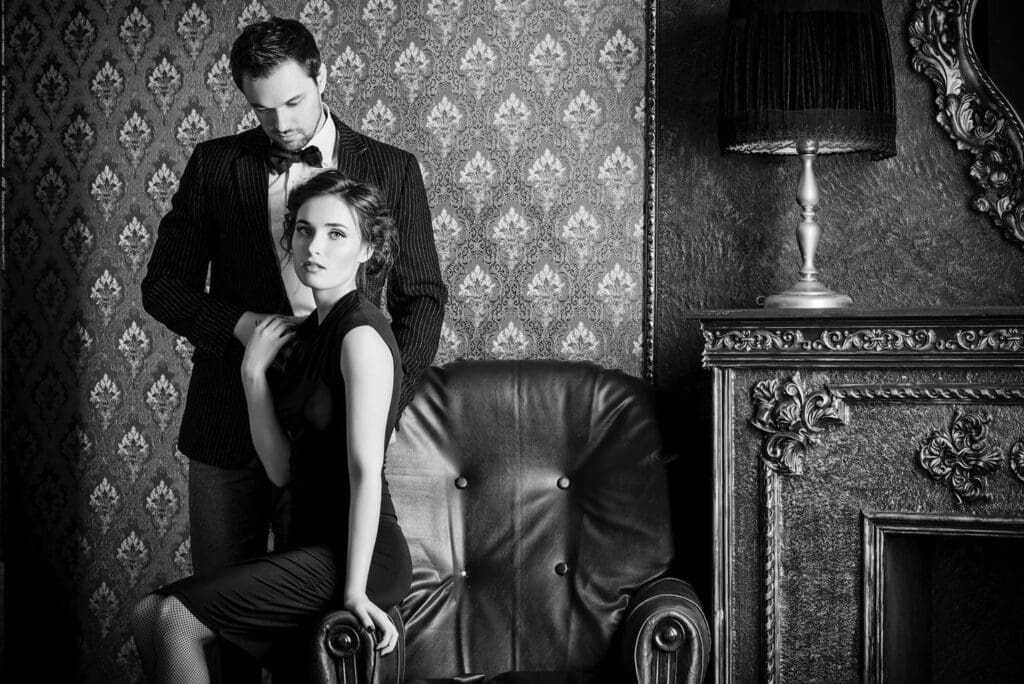 Beautiful man and woman in elegant evening clothes in classic vintage apartments. Glamour, fashion.