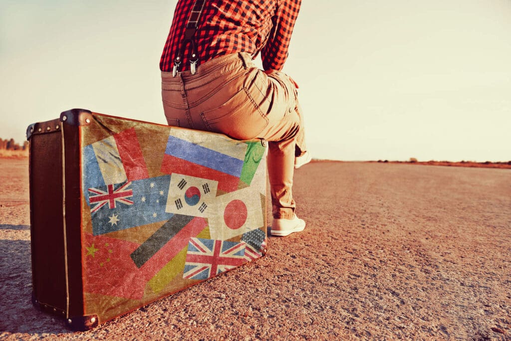 Tourist Sitting On A Suitcase