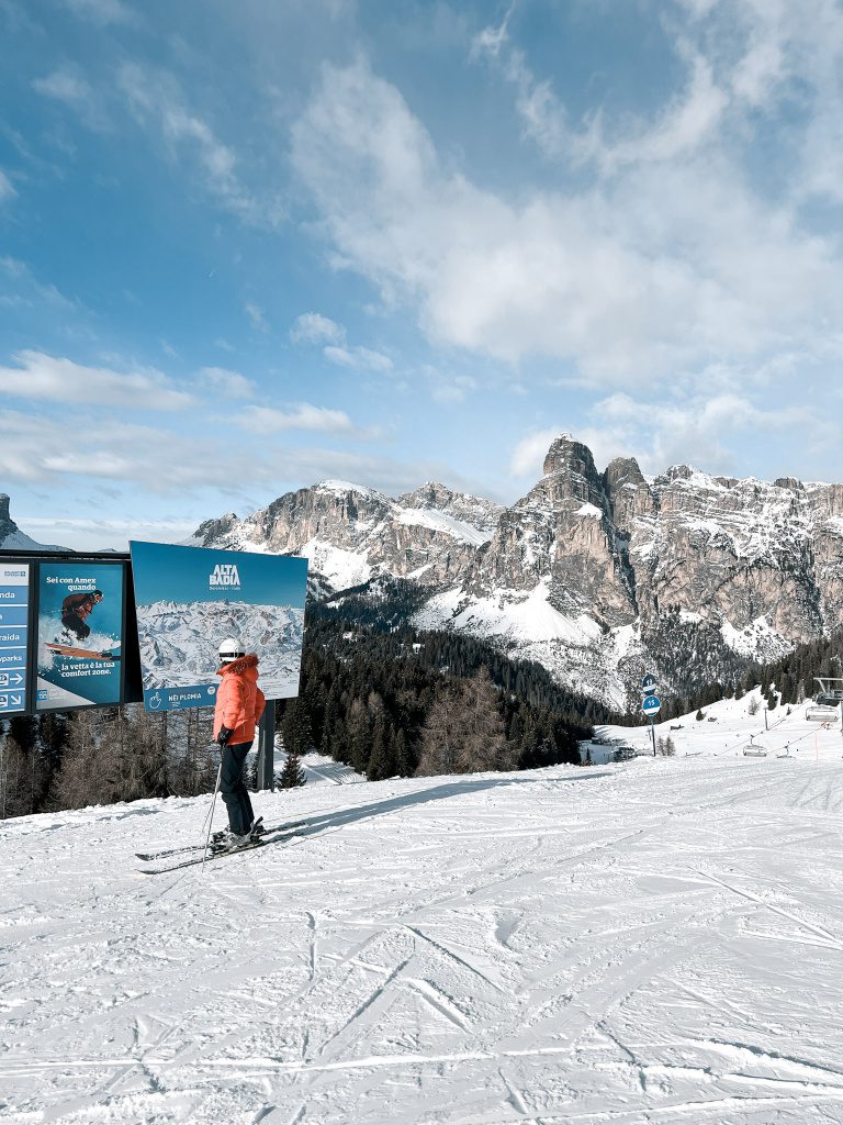 Skiër bekijkt Alta Badia sign met Colmar kleding