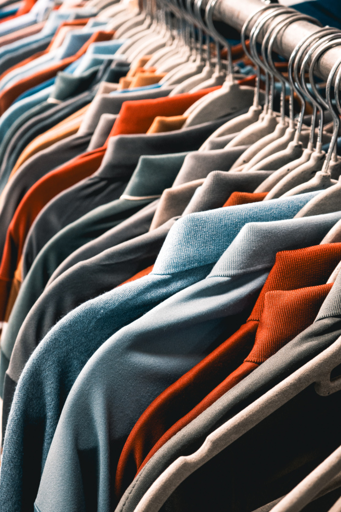 Stang met kleren aan hangers in kleuren